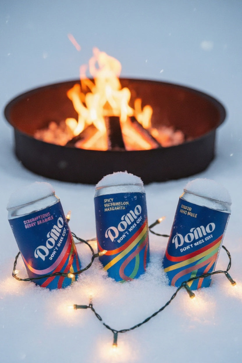 Do'Mo Functional Drinks in the snow beside a Fire pit